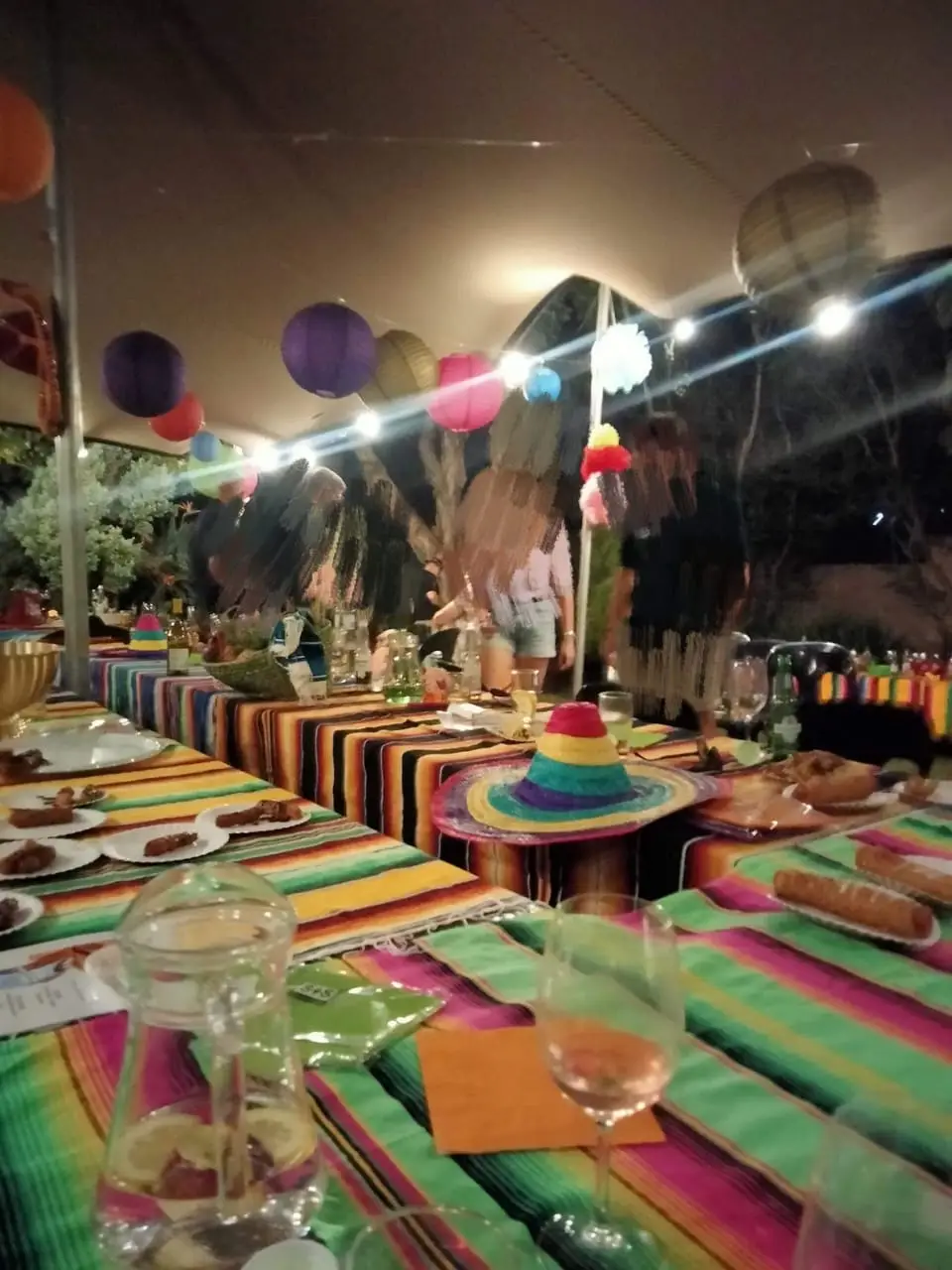 Outdoor party table with colorful decor and food