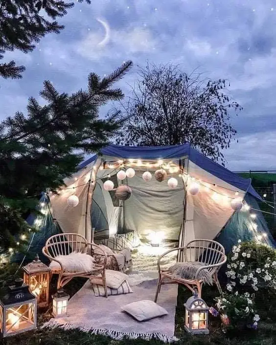 Outdoor tent decorated with lights and chairs