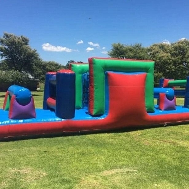 Colorful inflatable obstacle course on grass.