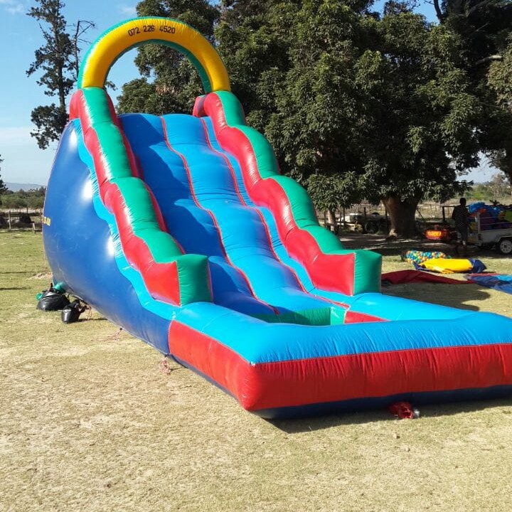 Large colorful inflatable slide in outdoor setting