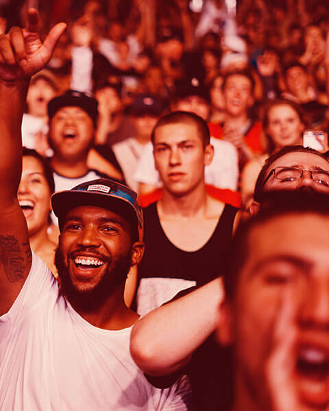 A lively crowd enjoying an event with enthusiastic expressions.