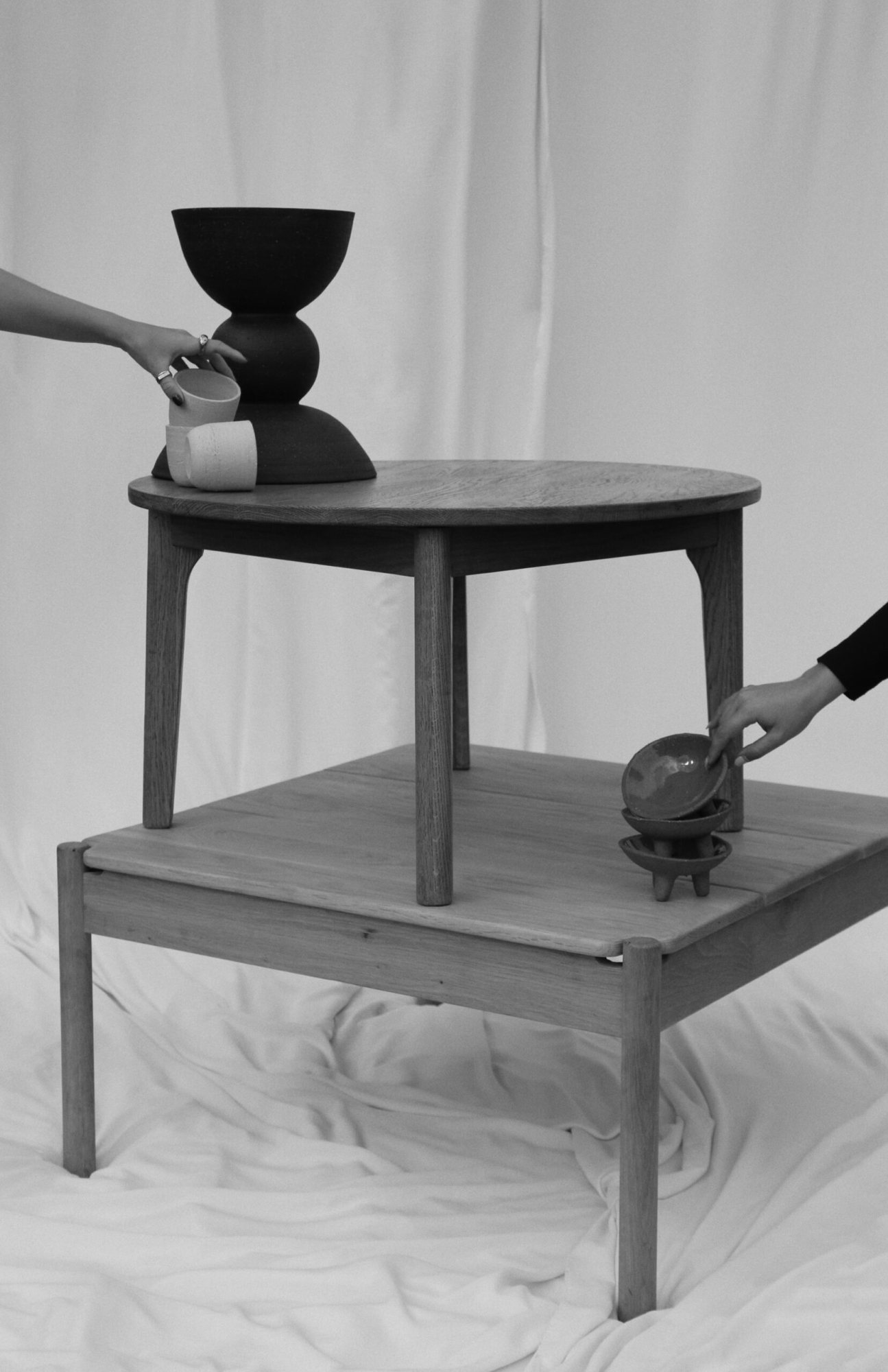 A minimalist wooden table with decorative bowls and cups