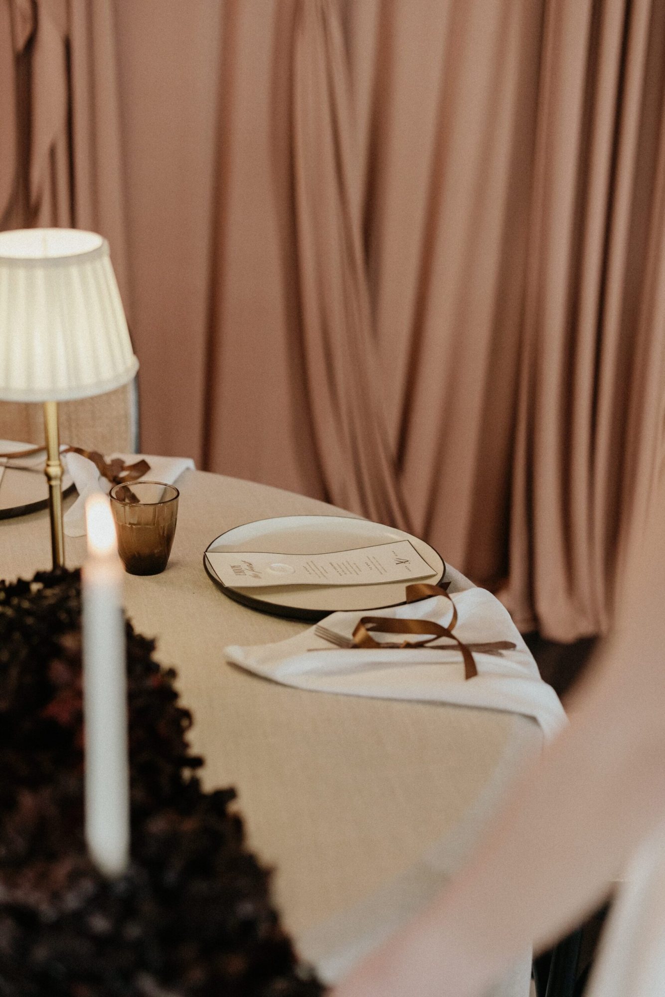 Tastefully arranged table with elegant tableware and soft linen.