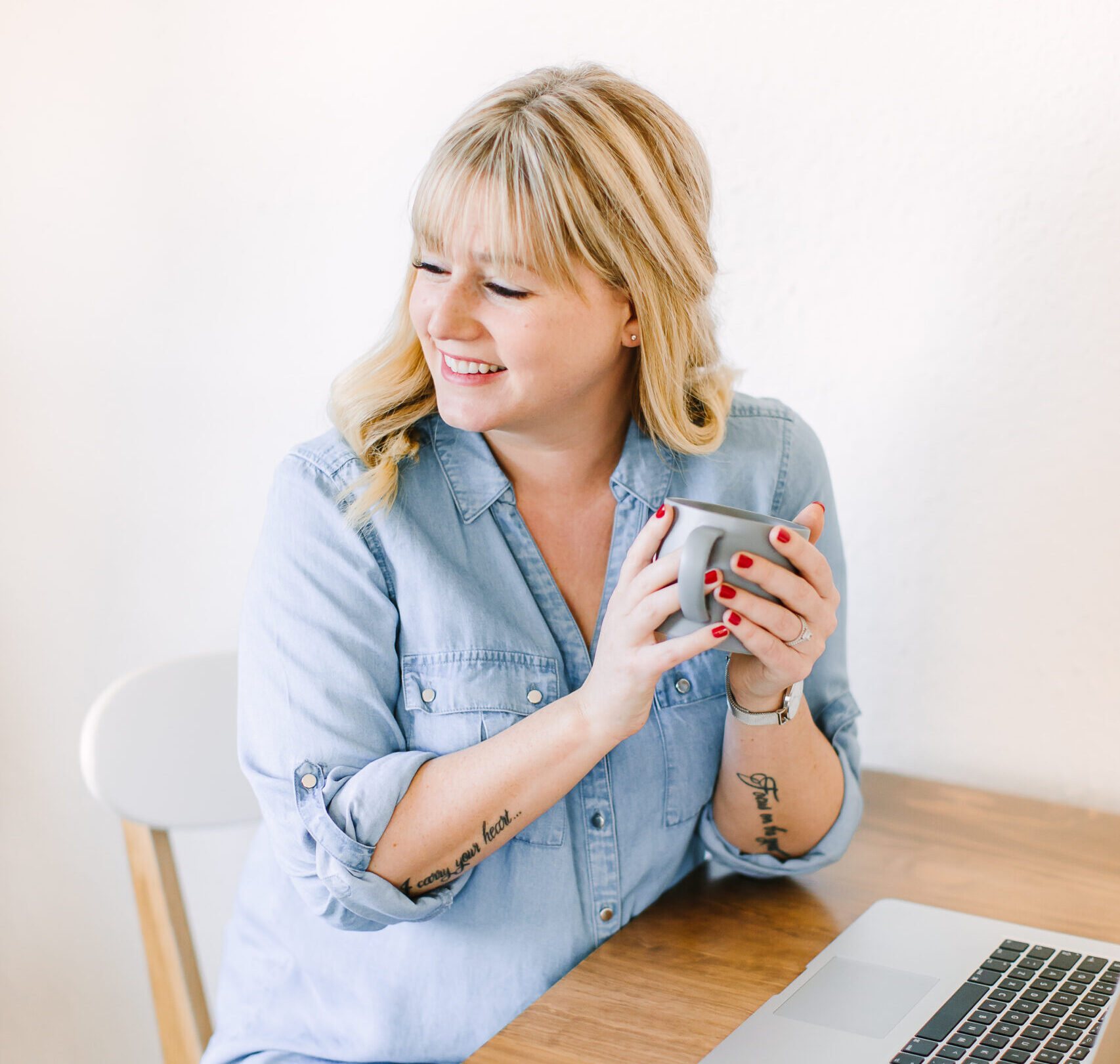 Smiling consultant holding a mug during a client meeting