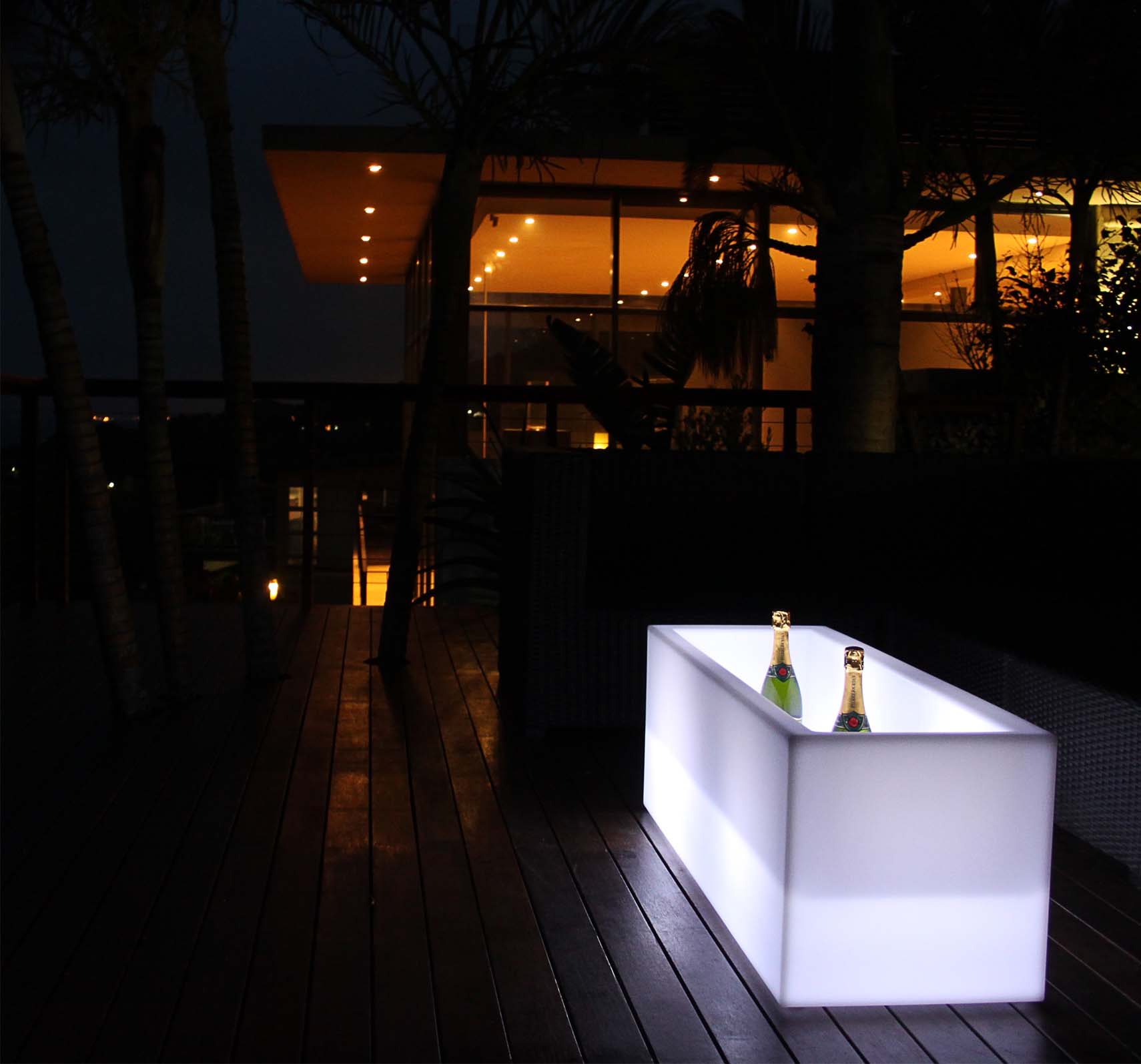 LED illuminated cooler with champagne bottles on a wooden deck