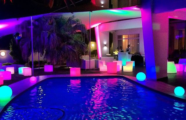 Illuminated pool area with colorful LED furniture