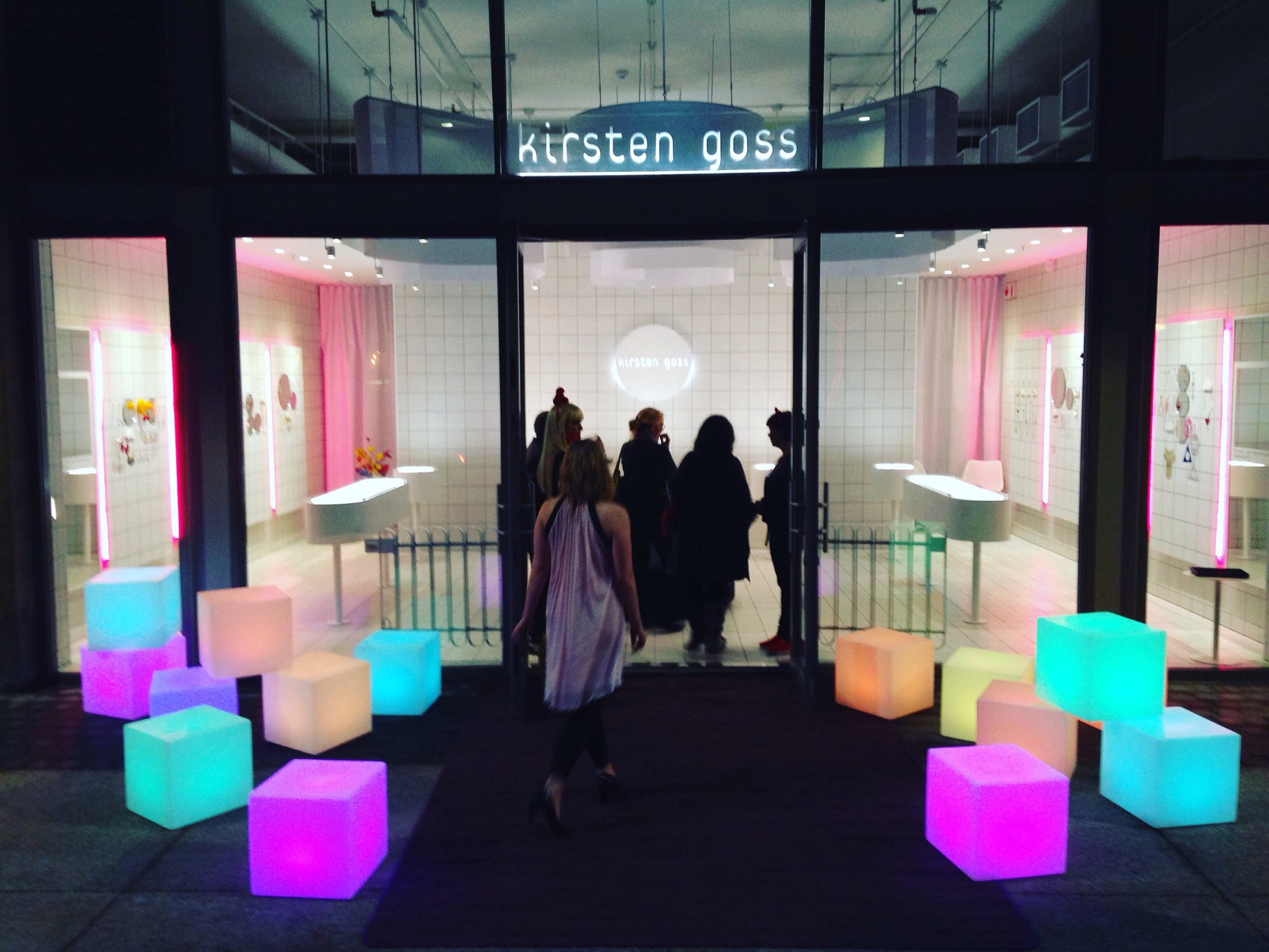 Colorful LED cubes at a stylish storefront entrance.