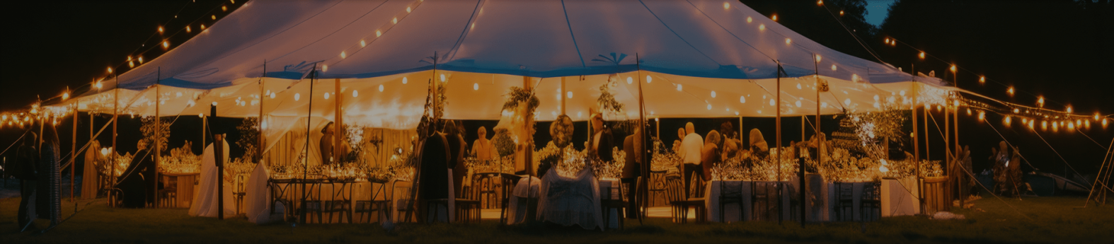 Stretch tent with fairy lights and tables set for an event