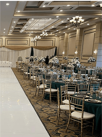 Elegant event space with tables set and floral arrangements