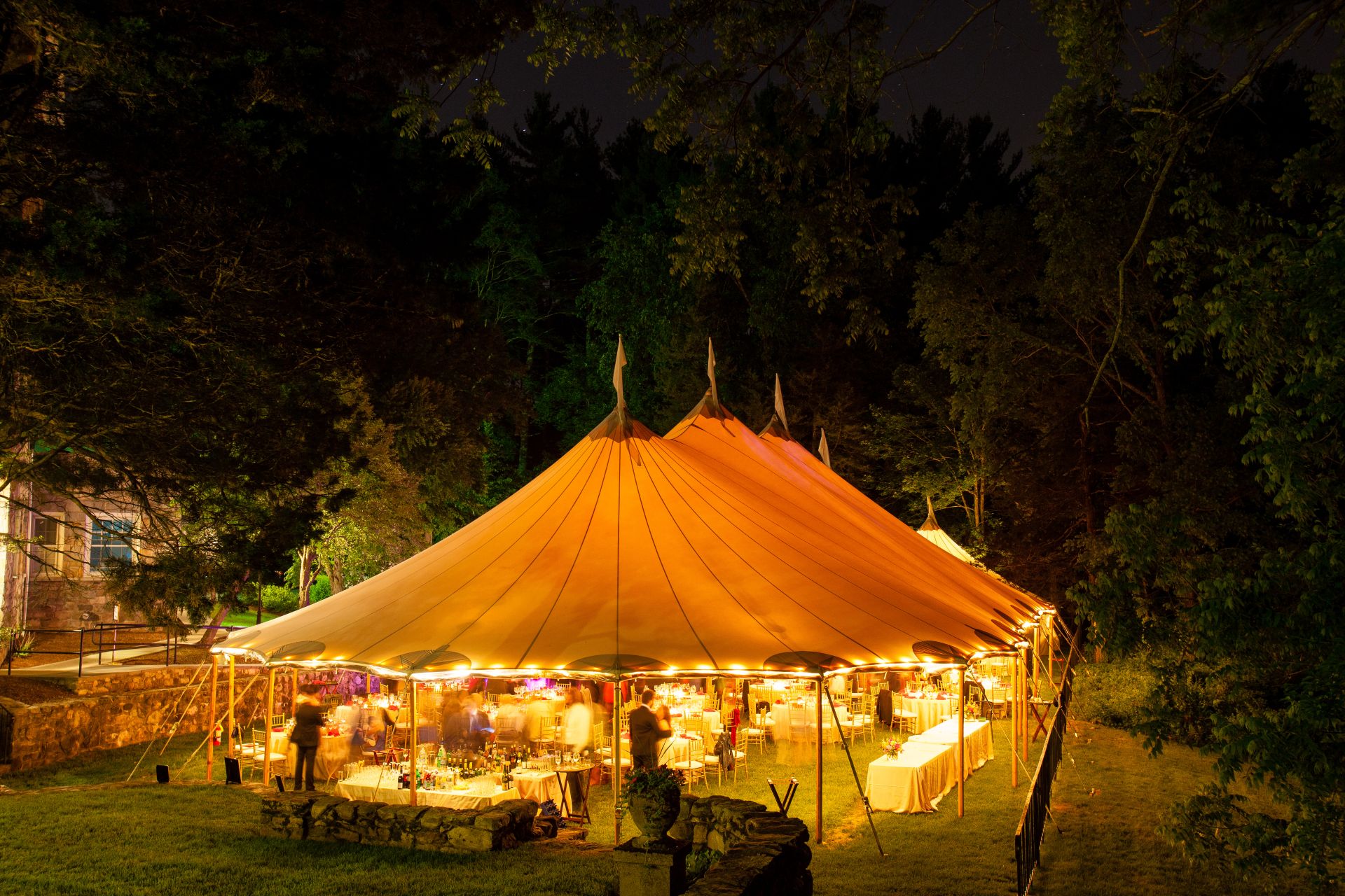 Large illuminated stretch tent in outdoor setting