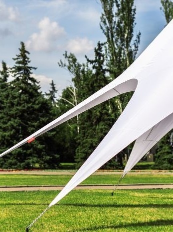 White stretch tent on green grass