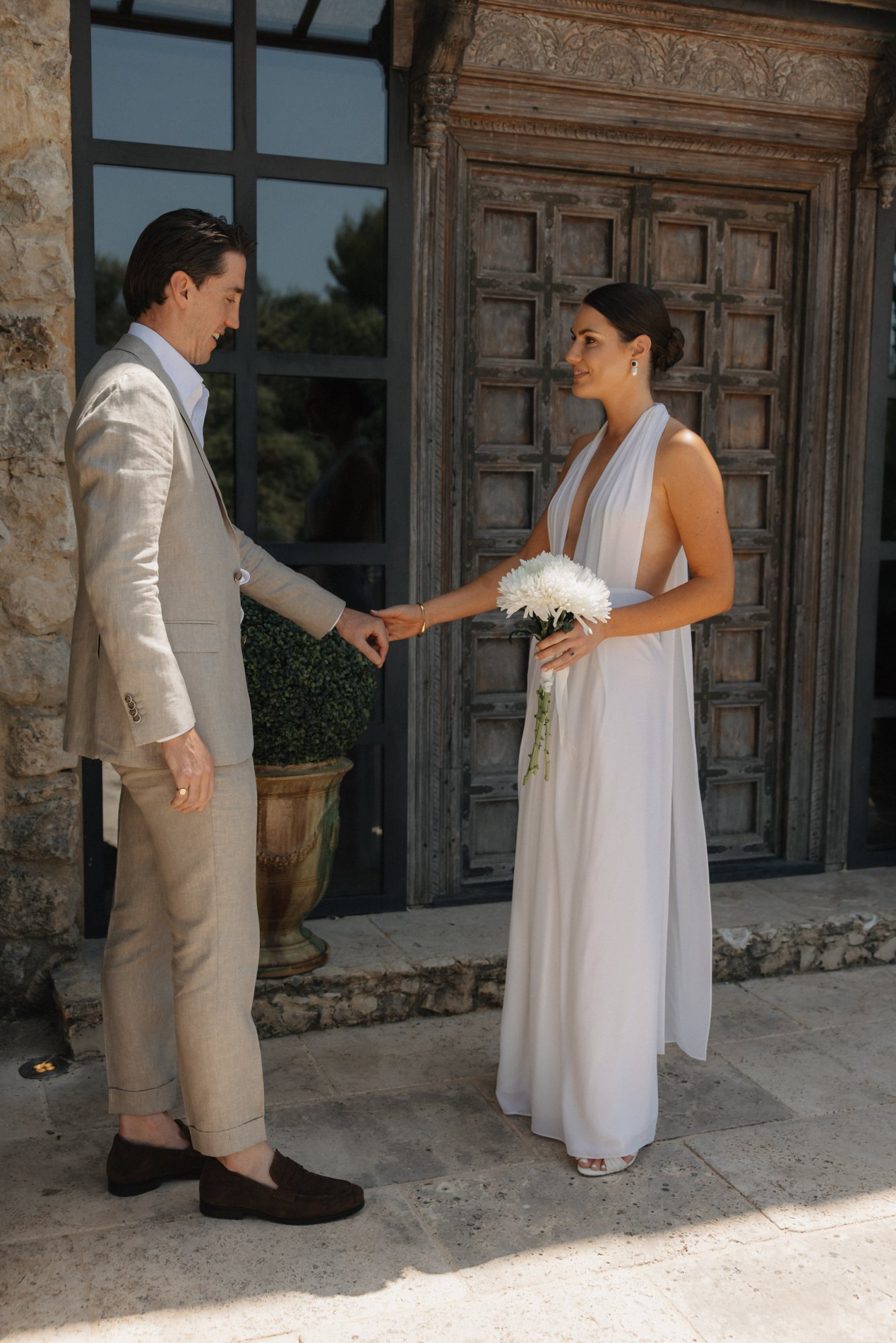 Couple exchanging rings at a garden wedding ceremony