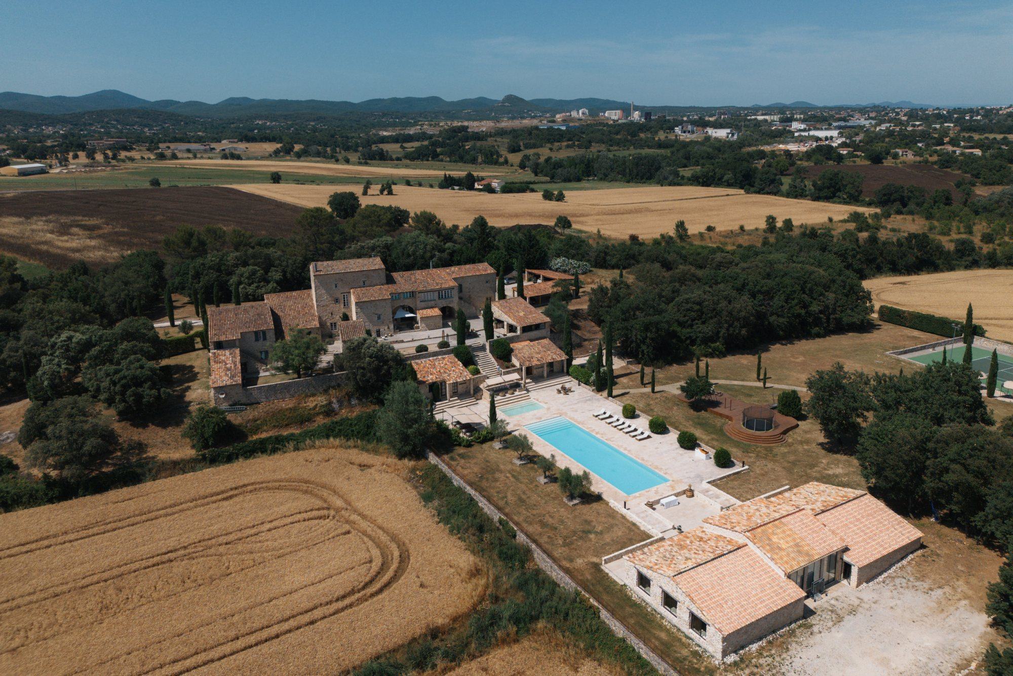 Aerial view of a scenic garden venue with a pool and surrounding landscape.