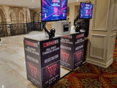 Registration setup for the Inland Trade Show with monitors and kiosks.