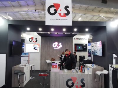 Exhibition booth with G4S branding and a staff member.
