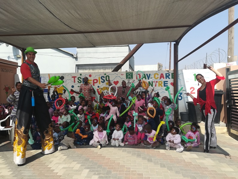 Children at daycare with balloon animals and entertainers