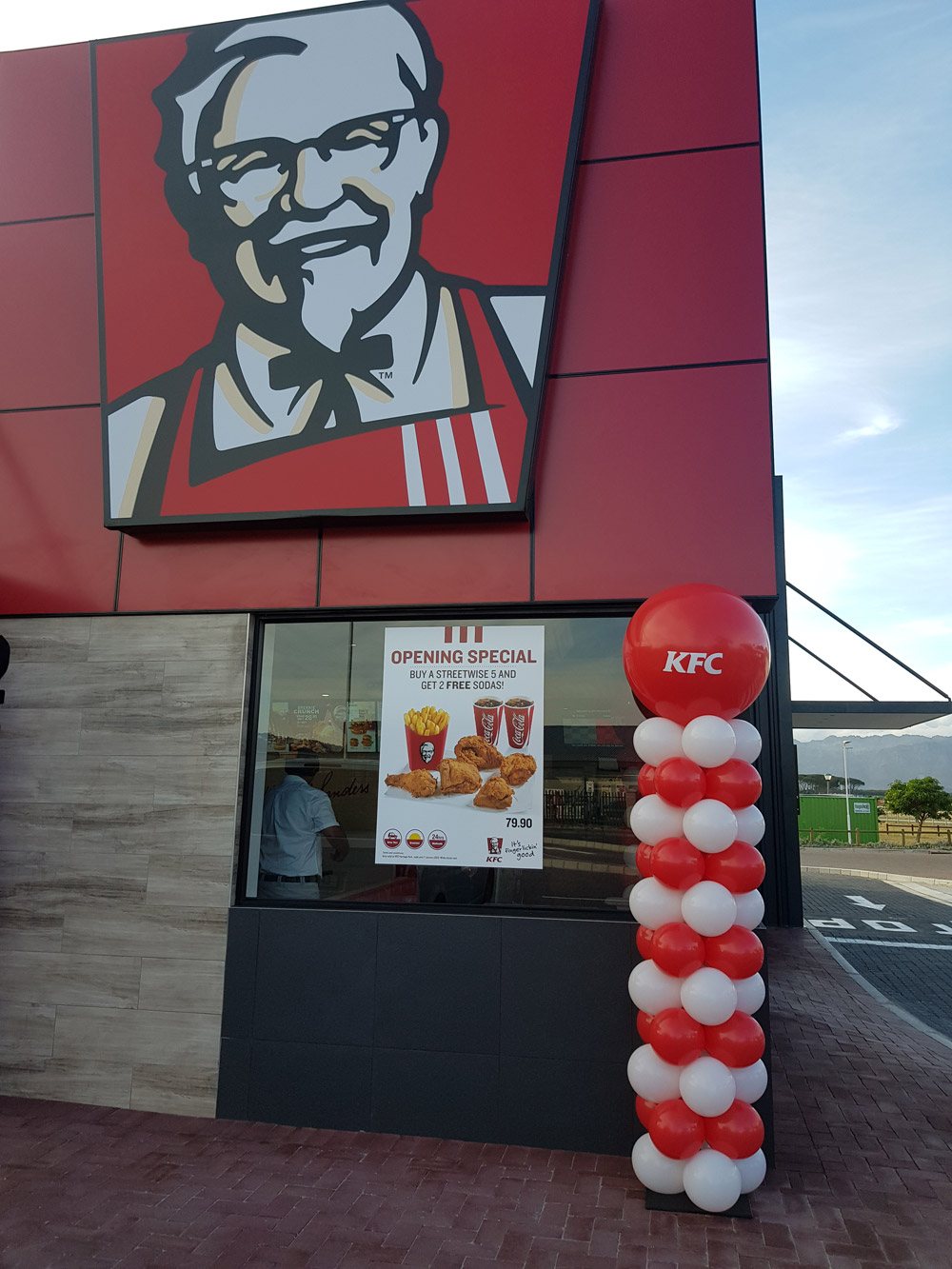 KFC opening with a red and white balloon column.