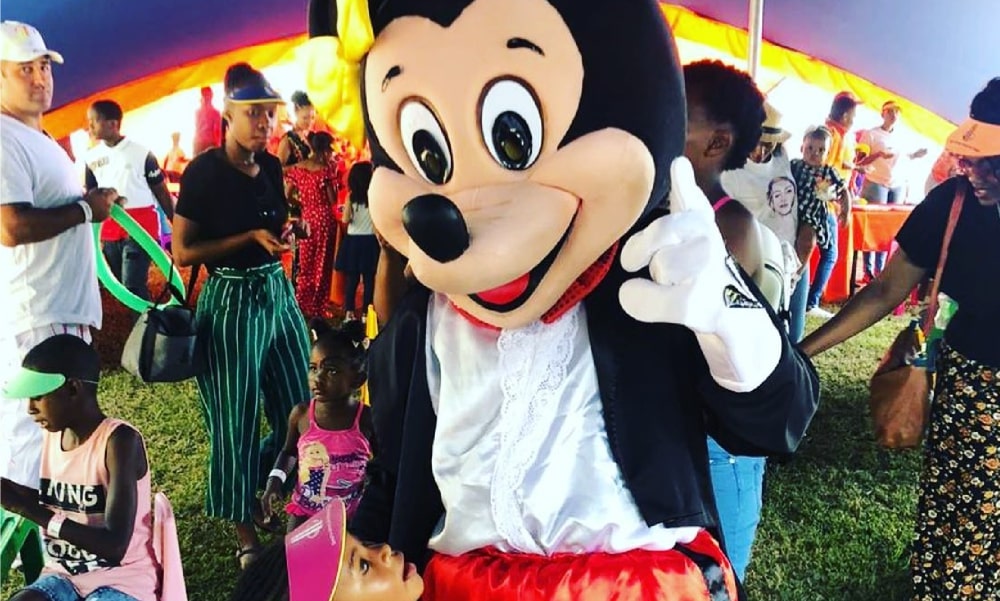 Character mascot interacting with children at a party
