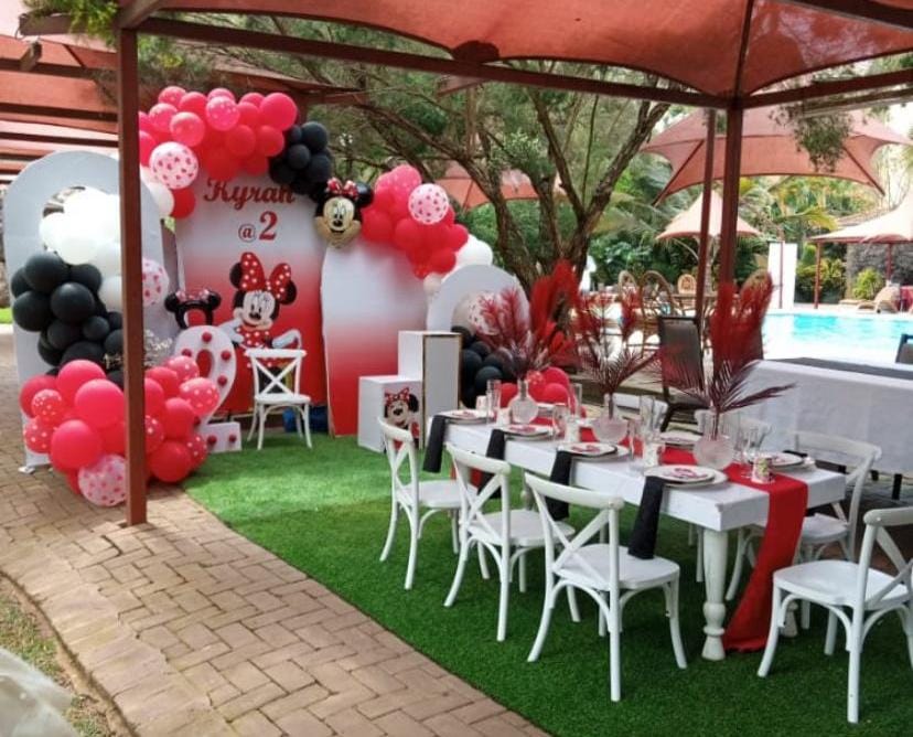 Minnie Mouse themed birthday setup with balloons and chairs