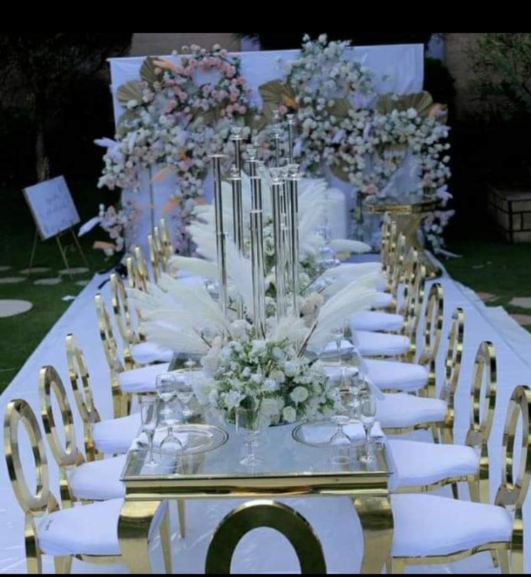 Long table setup with white flowers and gold accents