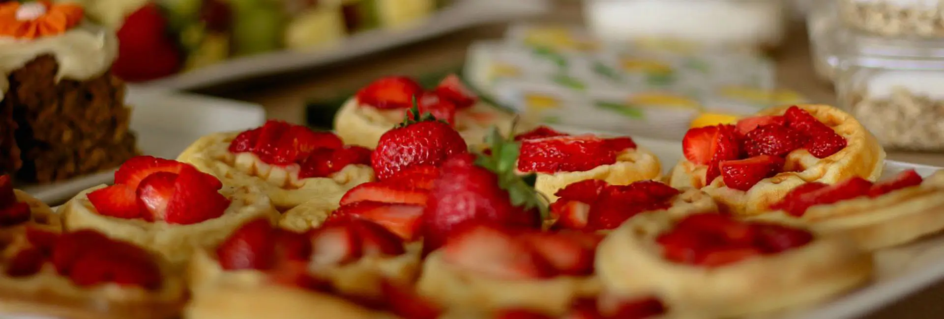 Pastries with strawberries on a dessert table