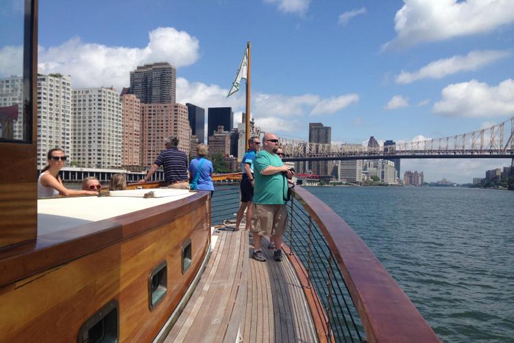 Guests on a yacht with city skyline and water views