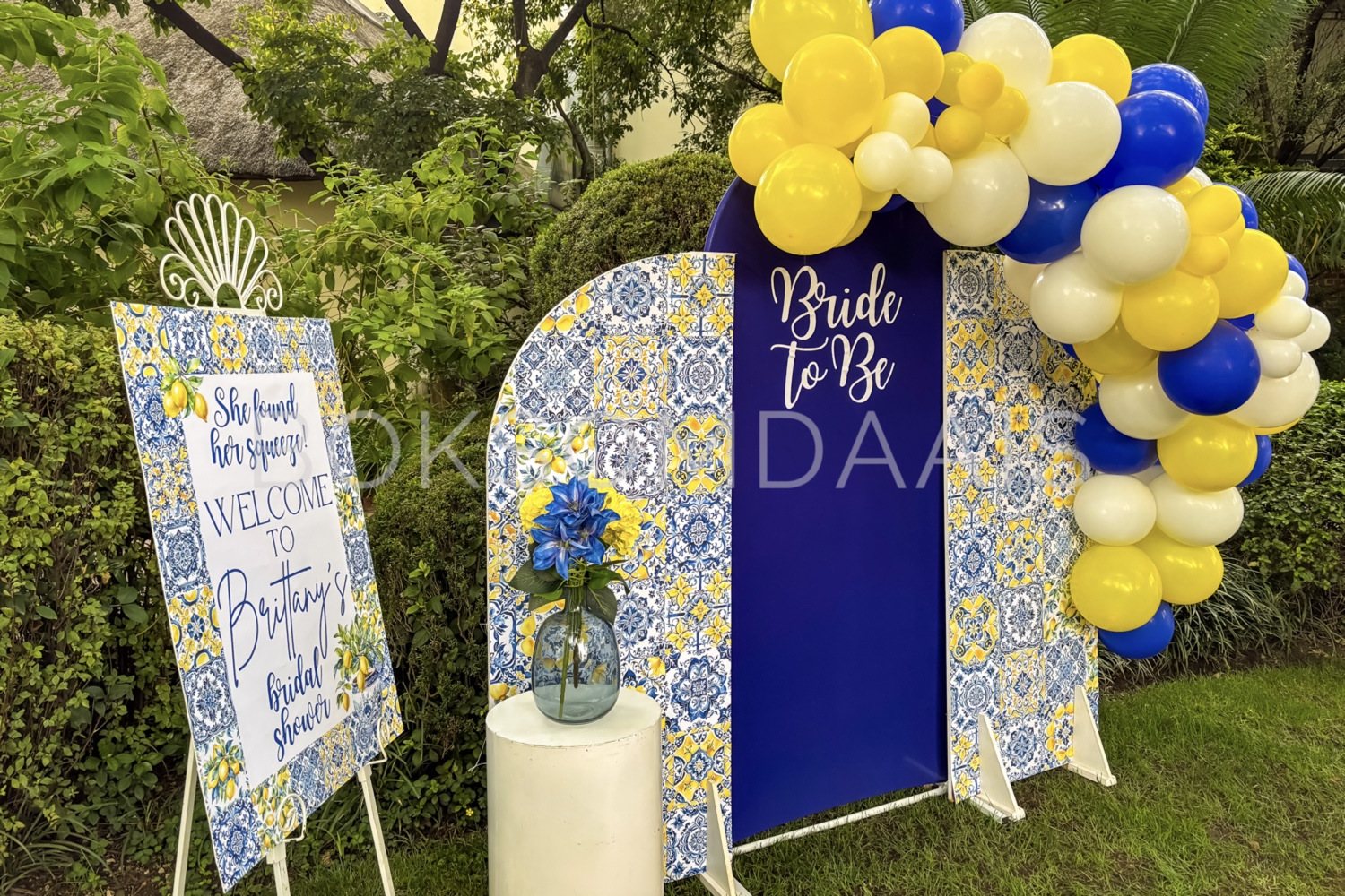 Colorful bridal shower backdrop with balloons and welcome sign.