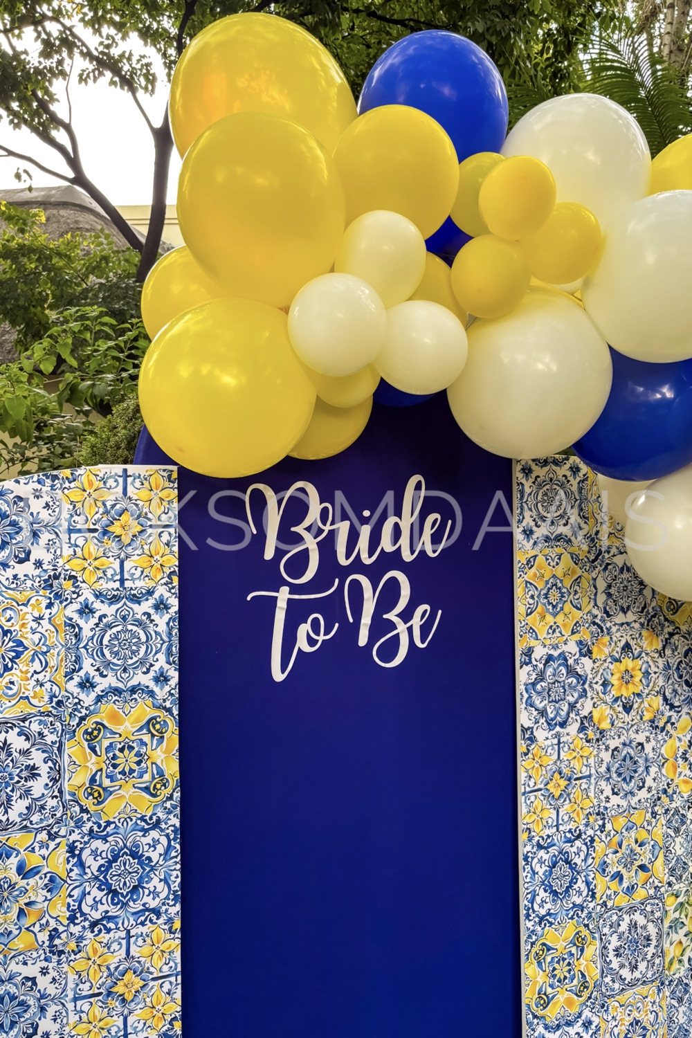 Blue backdrop with 'Bride to Be' text and colorful balloons