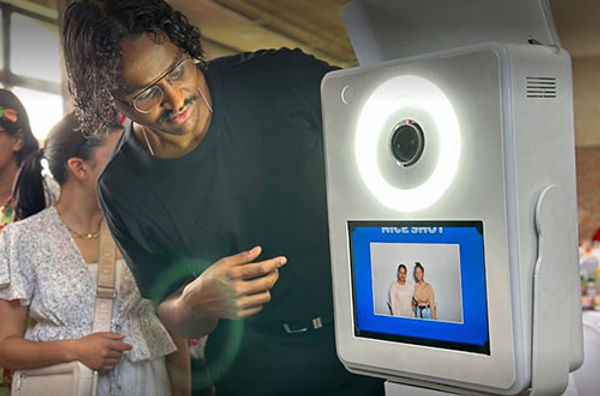 User interacting with a modern photo booth display