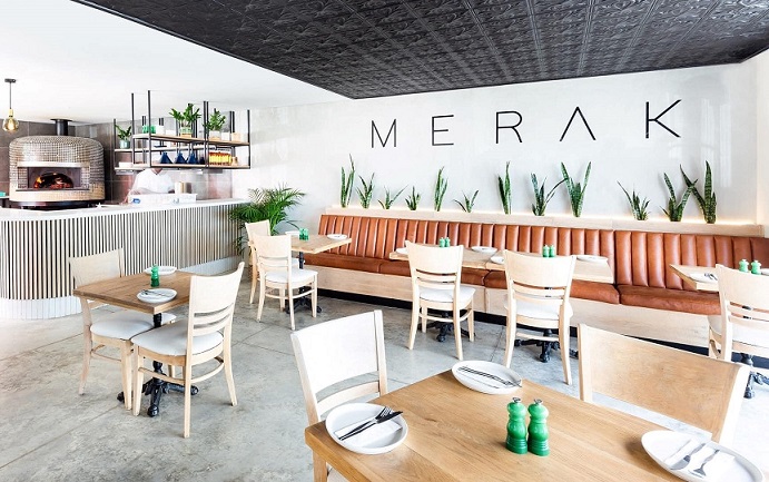 Interior of Merak restaurant featuring wooden tables and modern decor