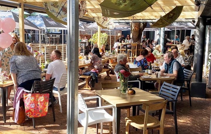 Busy restaurant interior with tables and patrons