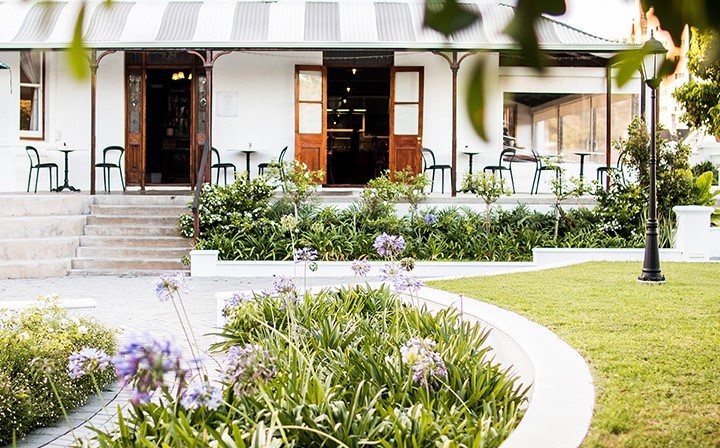 Exterior view of a venue with gardens and seating area