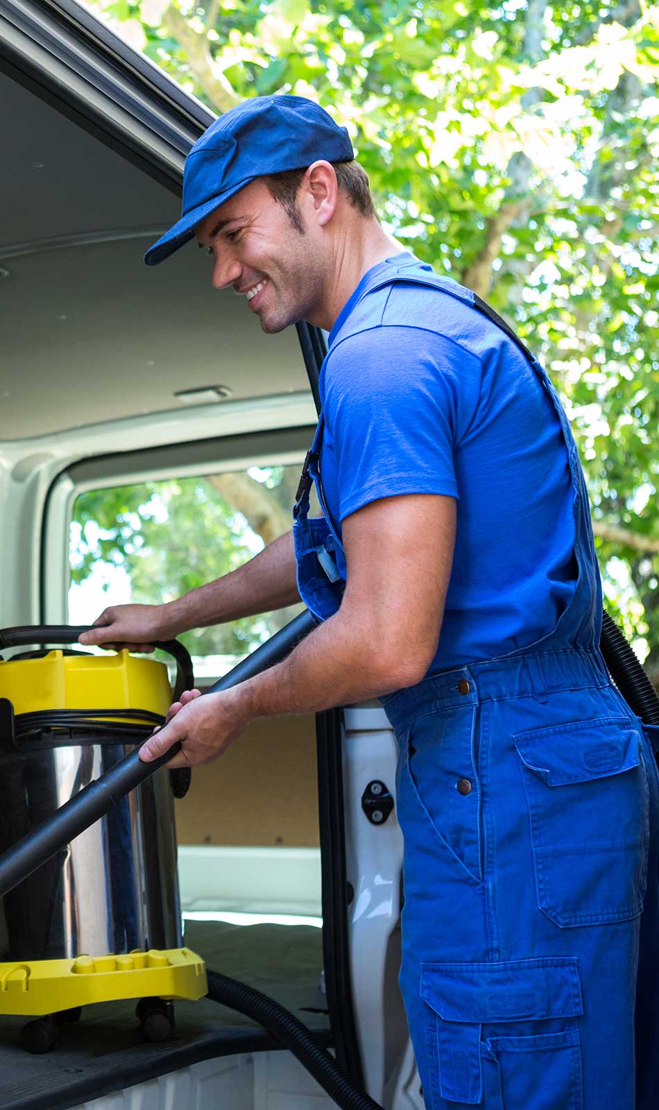Worker connects vacuum cleaner in van
