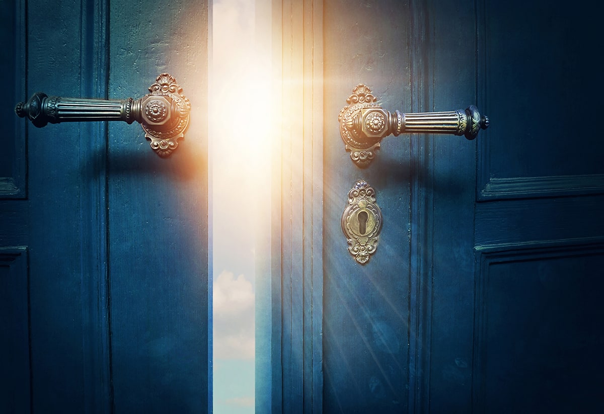 Partially open doors with sunlight shining through