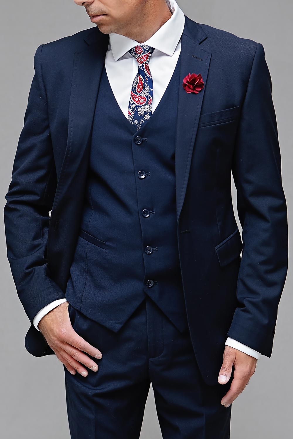 Model wearing a navy tuxedo with a floral tie