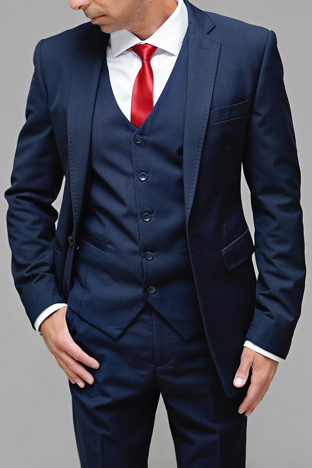 Man in navy tuxedo with red tie