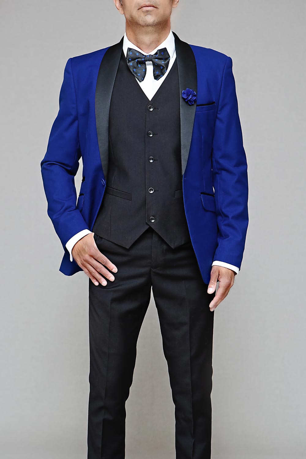 Model wearing a royal blue tuxedo with a black vest