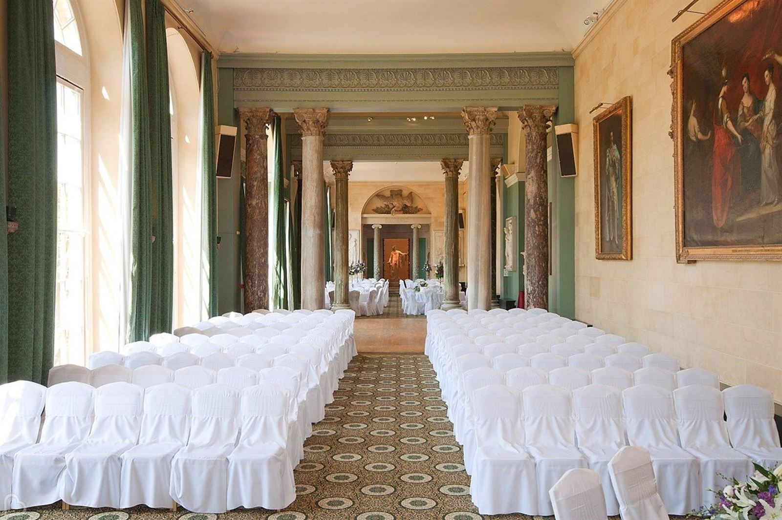 Rows of white chairs in an elegant wedding venue