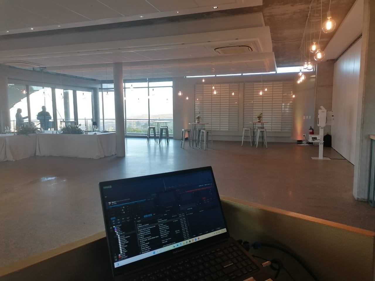 Modern event space with tables and lighting setup
