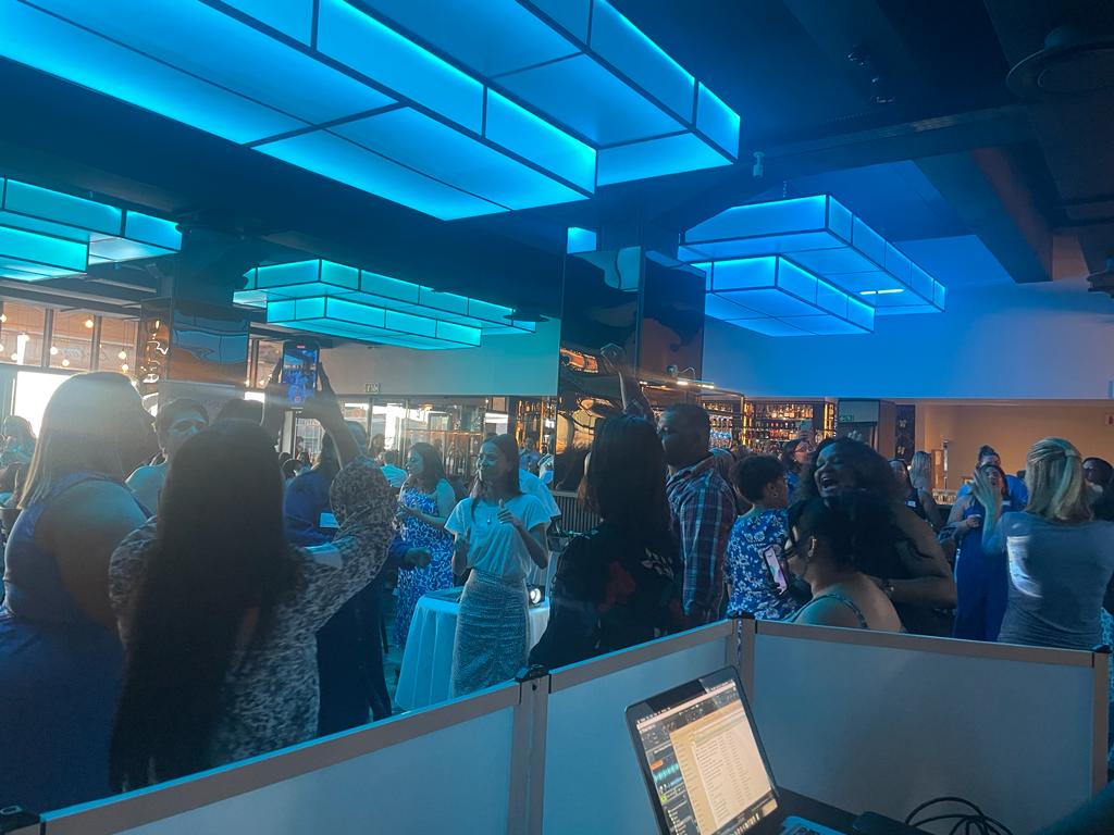 Guests enjoying a vibrant atmosphere under blue lighting