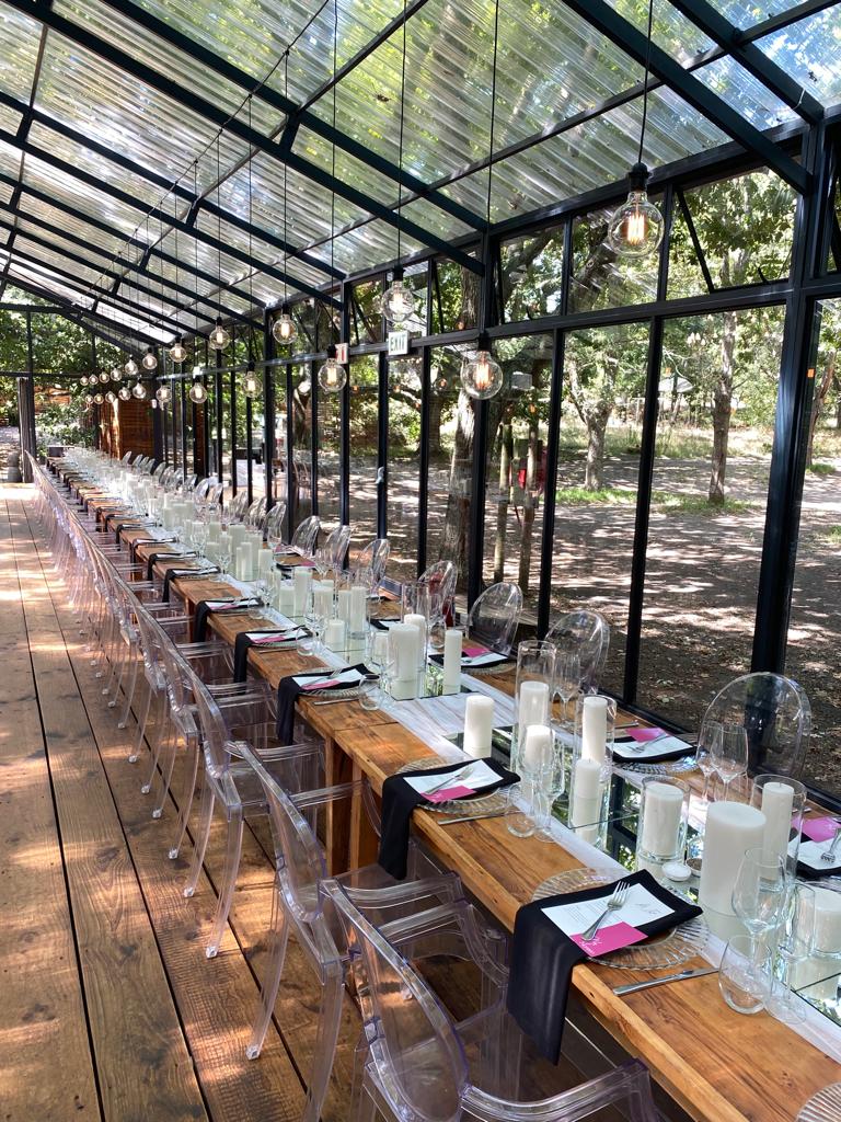 Long table setup with candles and glassware in a venue