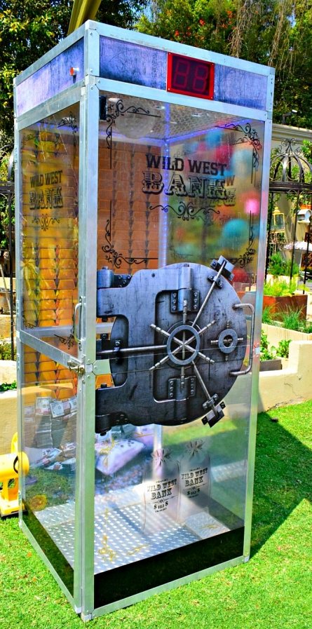 Wild West-themed bank game booth with vault door and digital timer