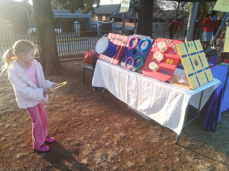 Child playing ring toss at a carnival game