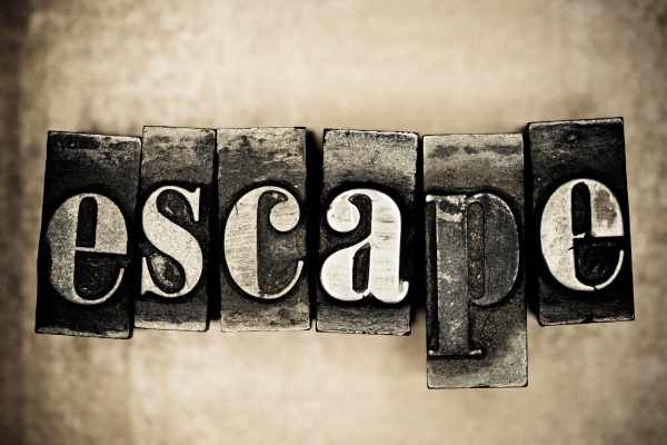 The word 'escape' in vintage print blocks.