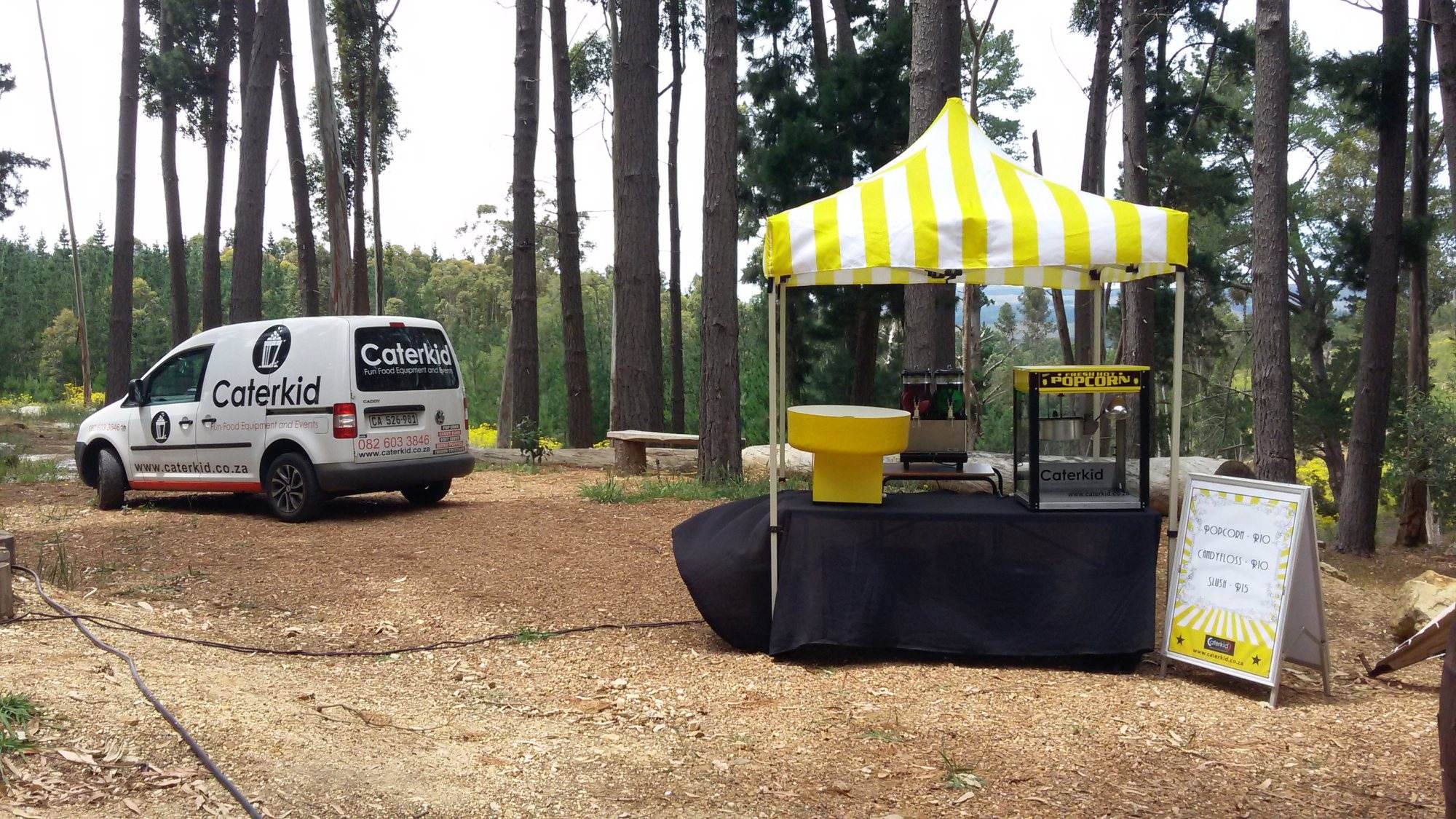 Caterkid fun food machine setup with a vehicle and tent in a forest