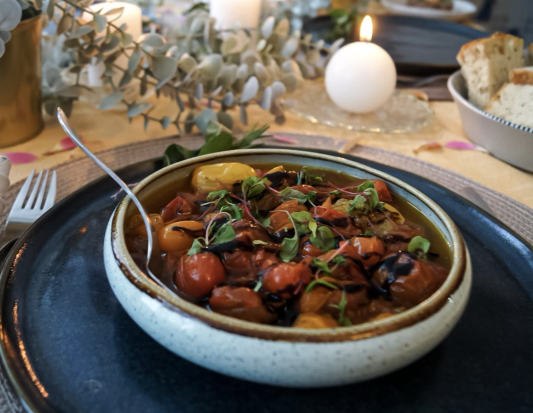Mediterranean dish of vibrant tomatoes in a rustic bowl