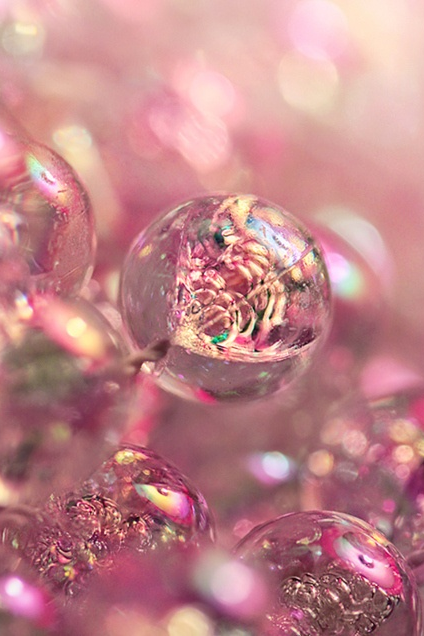 Close-up of decorative beads in soft pink tones.