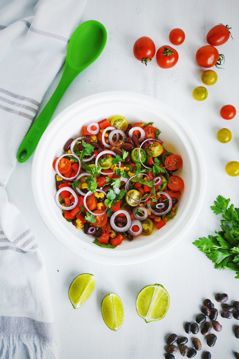 Bowl of colorful garden salad with tomatoes and herbs
