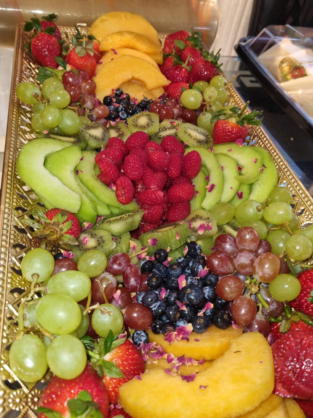 A beautifully arranged fresh fruit platter with various fruits