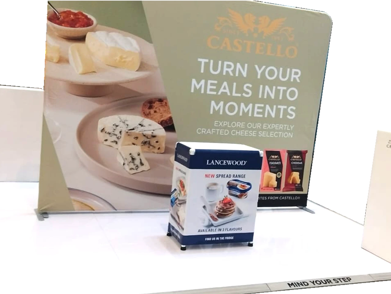 Cheese display with promotional signage at an event.